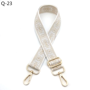 Close-up of bohemian floral guitar style replacement bag strap with golden metal clasps