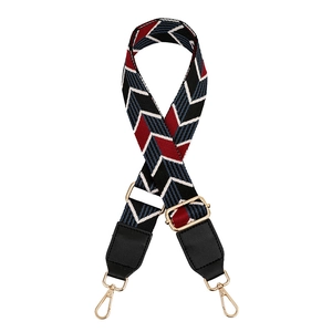 Close-up of adjustable colorful woven bag strap with golden lobster clasps and leaf pattern