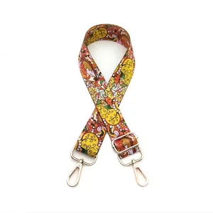 Close-up of bohemian paisley floral strap with gold metal swivel hooks and buckles