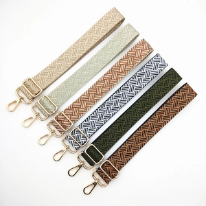 Adjustable woven shoulder strap with geometric patterns and gold metal lobster clasps