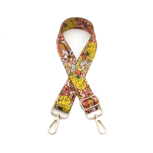 Adjustable bohemian style woven bag strap with paisley patterns and gold metal buckles