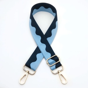 Detail of scalloped blue wave shoulder strap with gold-plated metal swivel hooks