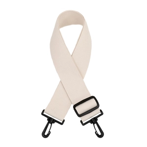 Close-up of adjustable beige canvas strap with black hardware and durable twill weave
