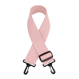 Detail of adjustable pink nylon bag strap with durable black plastic rotating hooks