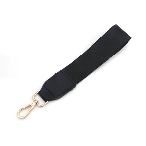 Detail of black woven strap with gold metal lobster clasp and premium leather reinforcement