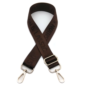 Detail of adjustable brown nylon strap with fashion jacquard and gold metal hooks