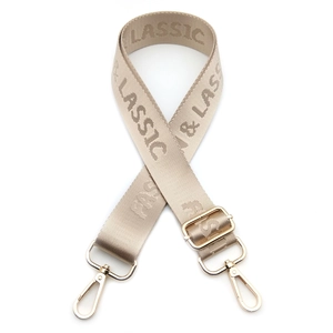 Close-up of adjustable nylon strap with Fashion & Classic lettering and gold hardware