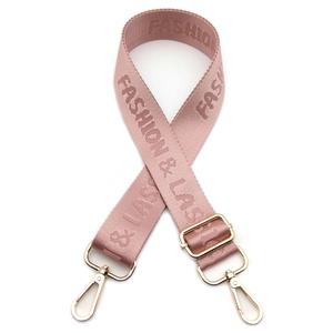 Detail view of adjustable nylon bag strap in rose pink with gold-tone metal hooks