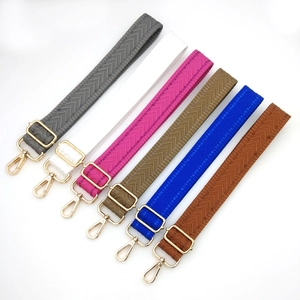 Adjustable woven shoulder straps with herringbone pattern and gold metal hardware