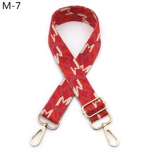 Adjustable red and white jacquard woven shoulder strap with letter M pattern and gold clips