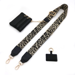 Close-up of leopard print wide strap with dual-zipper black pouch and gold hardware details