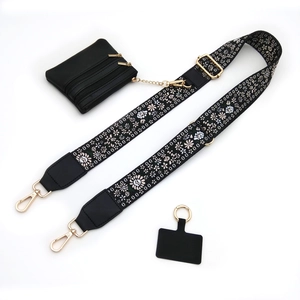 Detail of adjustable floral embroidery bag strap with mini black coin purse and gold hardware