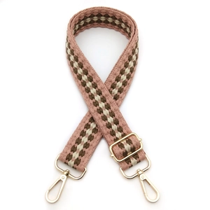 Detail of adjustable woven bag strap with pink checkerboard pattern and gold metal hooks