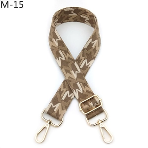 Close-up of adjustable woven bag strap with golden metal buckles and M-pattern design