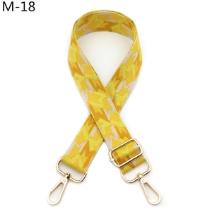 Adjustable woven shoulder strap in yellow geometric pattern with gold metal buckles