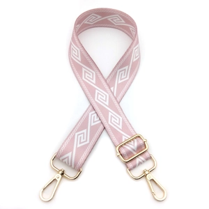 Detail view of adjustable pink and white diamond pattern strap with gold metal lobster clasps