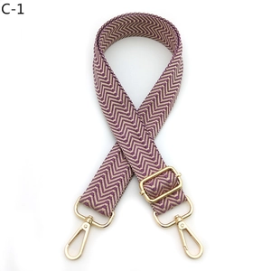 Detail view of purple and beige chevron woven strap with gold lobster clasps and buckles