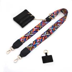 Detail view of colorful geometric strap, black coin purse and metal phone connector pad