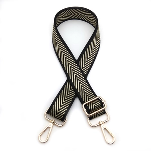 Detail view of adjustable black and gold woven strap with sturdy metal lobster clasps