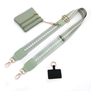 Adjustable avocado green shoulder strap with woven pattern and matching small zipper pouch