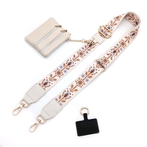 Close-up of adjustable ethnic embroidery strap with cream three-layer zipper coin pouch