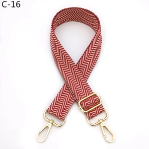 Detail of red and white chevron woven strap with adjustable gold lobster clasps