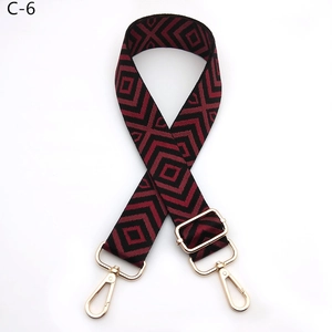 Detail of adjustable rhombus pattern strap with burgundy and black weave and gold hooks