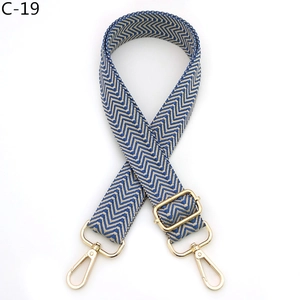 Close-up of blue and beige chevron woven strap with gold metallic adjustable buckle