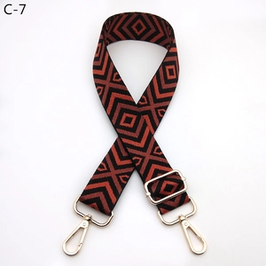 Close-up of diamond pattern woven shoulder strap with gold metal hooks and buckle