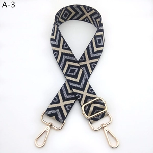 Detail of multi-color geometric rhombus woven strap with gold metal lobster clasp