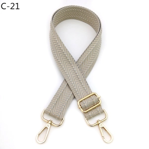 Detail of adjustable wide shoulder strap with grey chevron weave and gold metal hooks