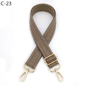 Detail of adjustable brown and beige wave pattern strap with gold metal swivel hooks