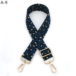 Close-up of leopard print bag strap with golden lurex thread and metal swivel hooks