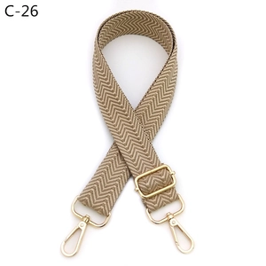 Close-up of adjustable herringbone bag strap with durable gold metal swivel hooks
