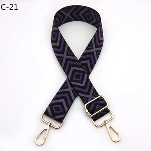 Detail of adjustable bag strap with purple diamond pattern and gold-tone lobster clasps