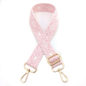 Macro detail of pink and white diamond pattern woven shoulder strap with gold alloy hooks