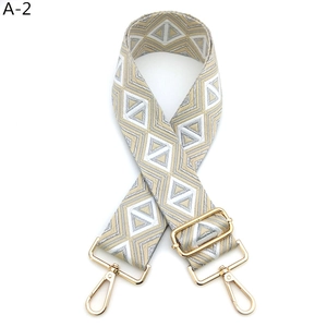 Detail of champagne gold geometric diamond weave bag strap with gold lobster clasps