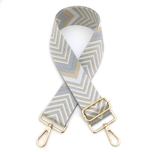 Adjustable wide woven bag strap with golden geometric V-pattern and metal hooks