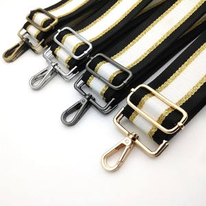 Detail of adjustable bag straps with gold wire stripes and multi-color metal hooks