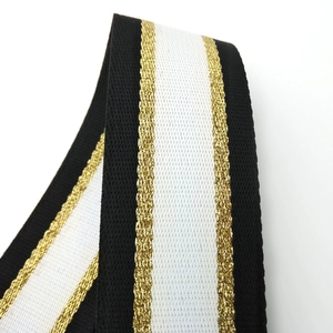Close-up of adjustable bag strap showing gold metallic thread and striped fiber texture