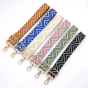 Adjustable woven replacement bag straps with geometric patterns and gold metal hardware