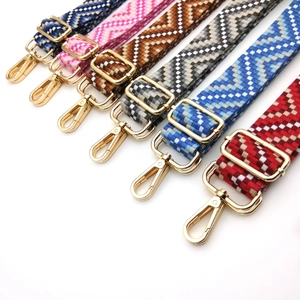 Selection of colorful geometric woven bag straps with gold metal hooks and adjustable buckles