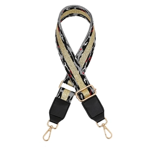 Close-up of leopard pattern bag strap with gold glitter stripe and metal lobster clasp