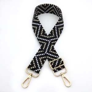 Detail of adjustable geometric wavy pattern strap with golden metal lobster clasps