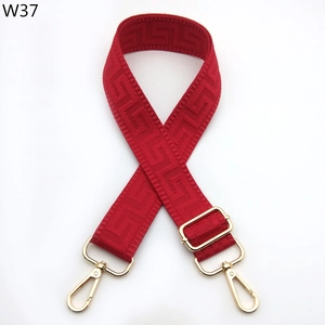 Detail of red jacquard strap with gold adjustable buckle and lobster hooks for bags