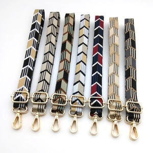 Adjustable woven shoulder straps with colorful arrow patterns and gold hardware