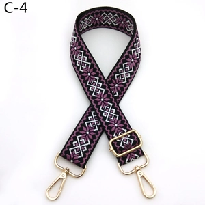 Macro shot of ethnic geometric pattern woven strap with gold metal lobster clasps