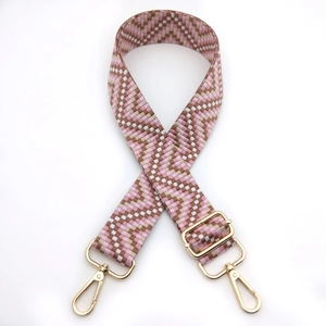 Close-up of pink and brown wave geometric pattern bag strap with gold lobster clasps
