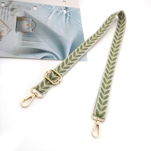 Adjustable crossbody strap with green leaf pattern and golden hardware for bags