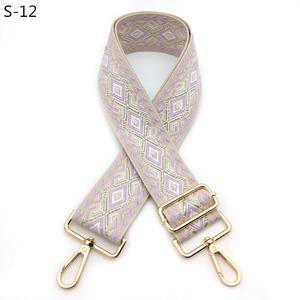 Detail of diamond pattern jacquard bag strap with gold metal swiveling hooks